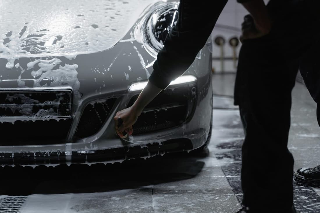Brand-new car being detailed with ceramic coating application.